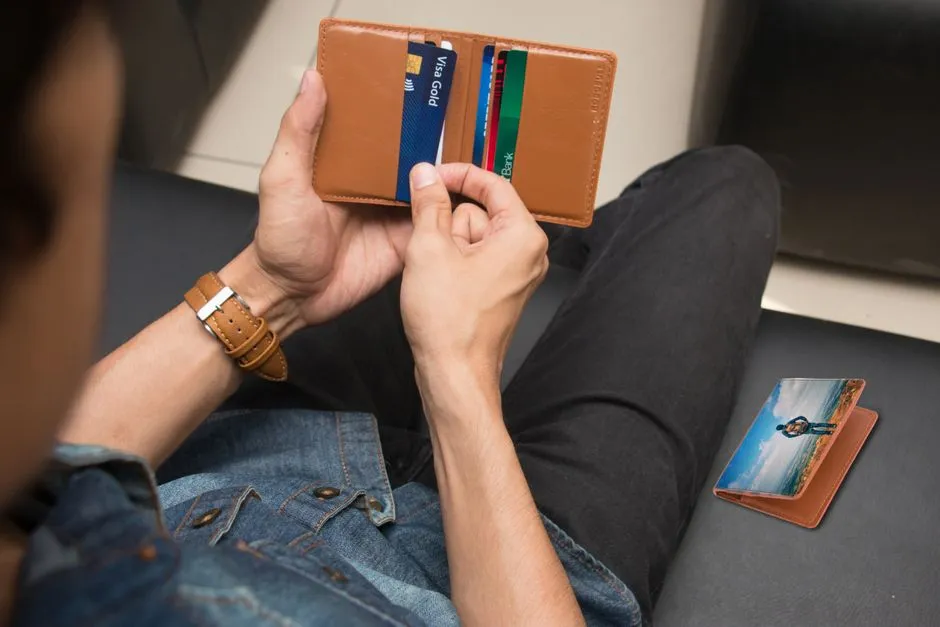 Close-up of a person holding a wallet with credit cards, illustrative photo